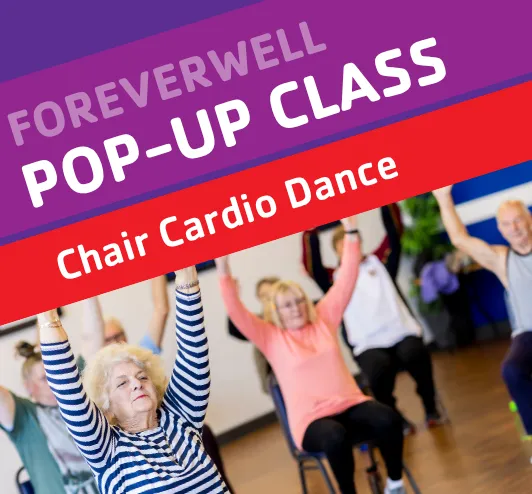 A group of older adults doing seated exercises.