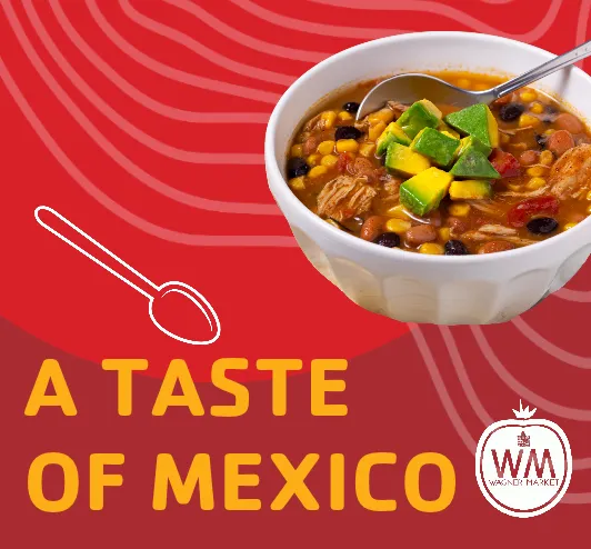 A bowl of Caldo de Res, a Mexican beef stew with corn, potatoes, avocados, and cotija cheese.