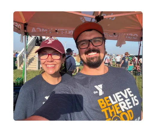Two volunteers in Y shirts taking a selfie.